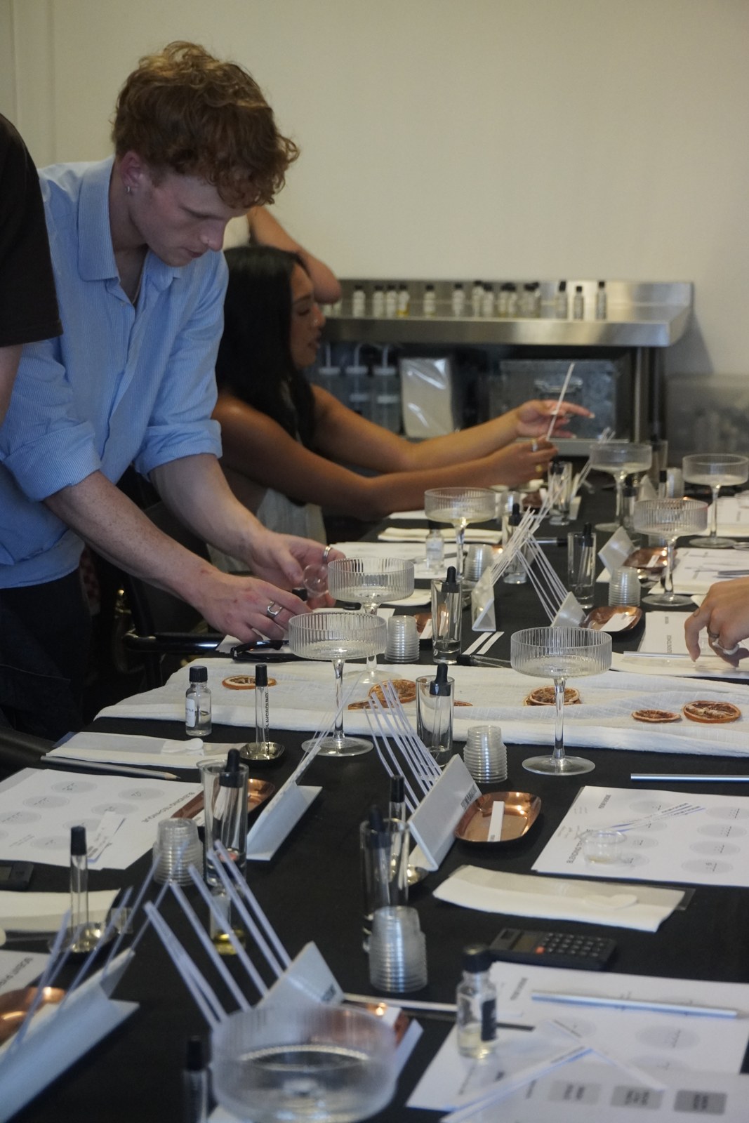 A participant blending fragrance with botanical essences during a Perfume Playground workshop.