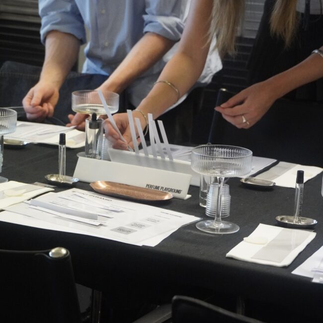 Workshop participants blending their own fragrances with pipettes.