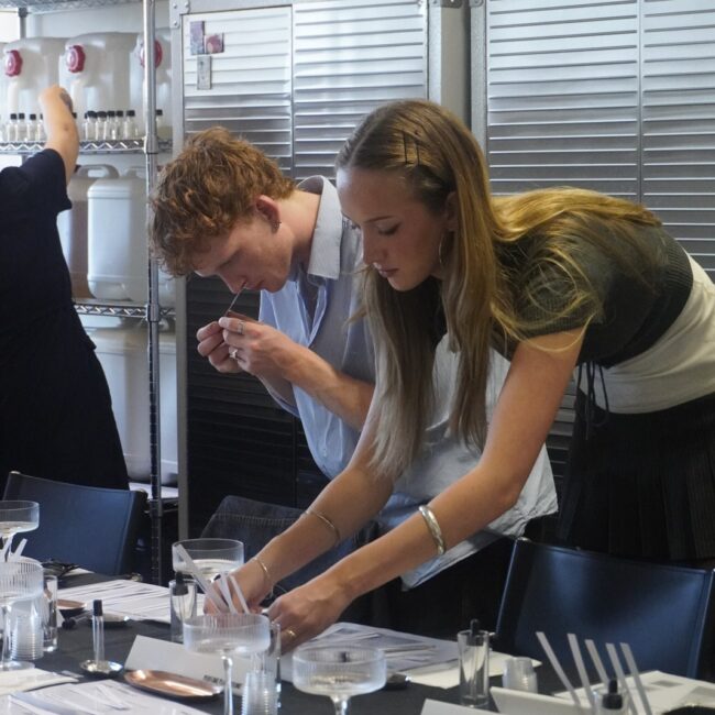 Two participants smelling botanical essences at a Perfume Playground workshop.