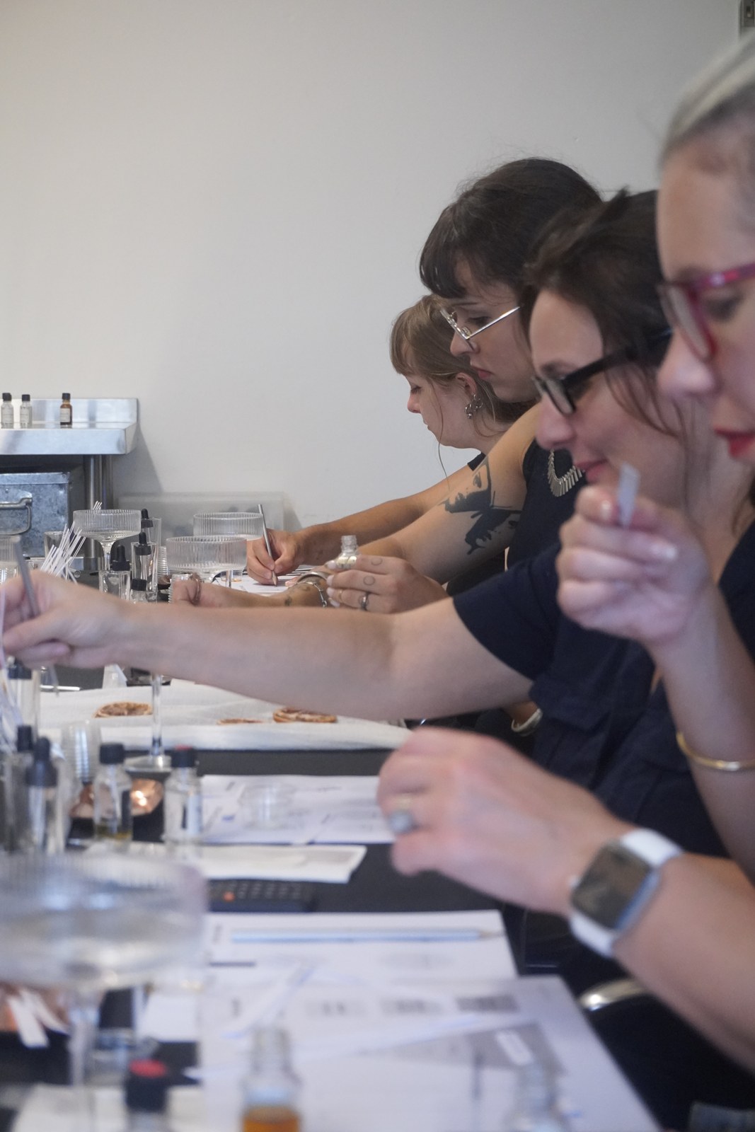 Participants smelling scent strips during a Perfume Playground fragrance workshop.