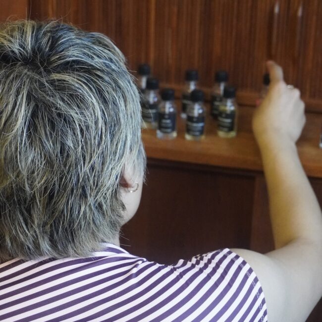 A participant choosing botanical essences from the Perfume Playground scent collection.