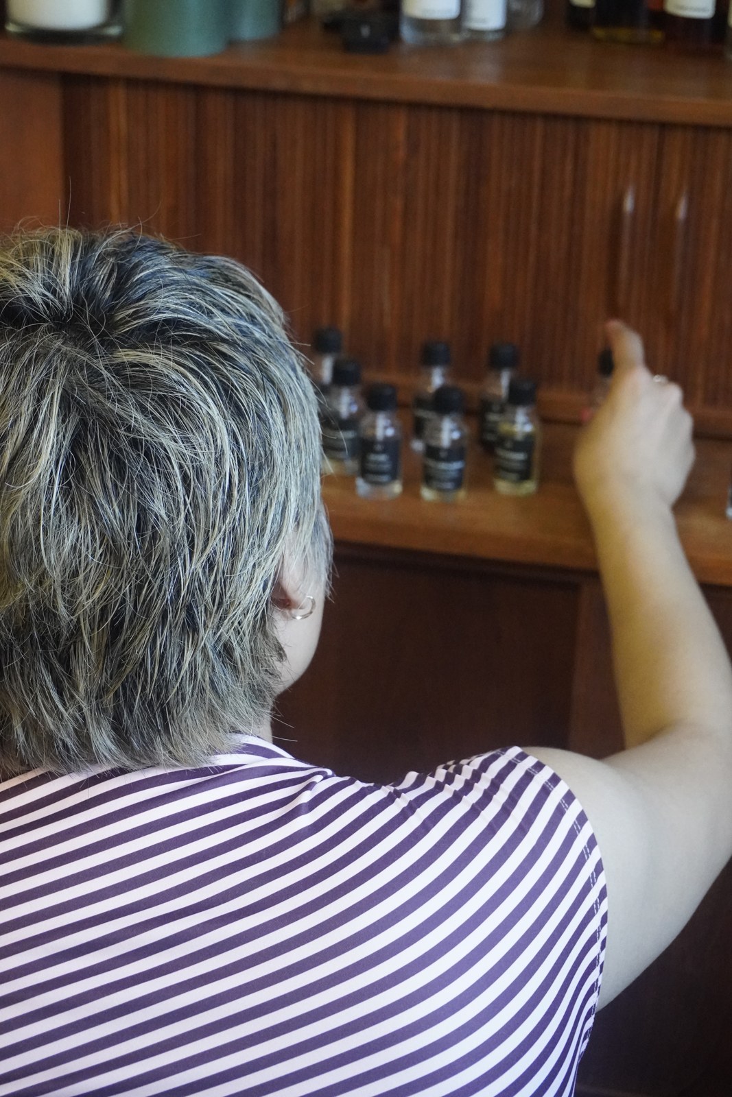 A participant choosing botanical essences from the Perfume Playground scent collection.